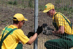 Installing a welded grid panel to a fence